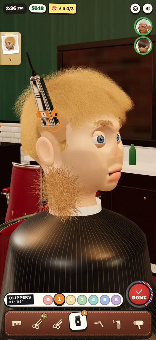 Mid-cut: the clippers on a #1 at his temple, one side of a curly head faded, clippings on the cape